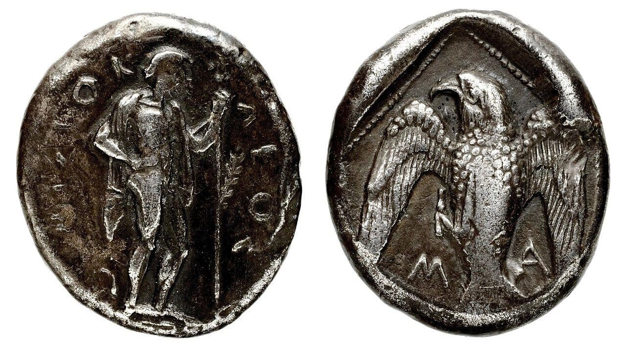 Ancient silver coin with a standing figure of Apollo on one face and an eagle on the other