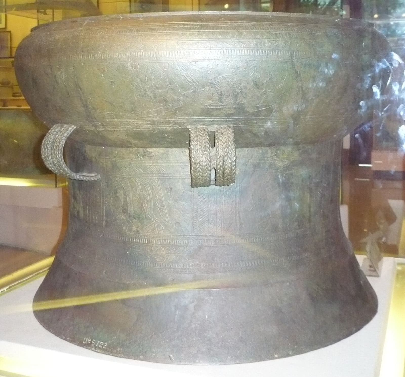 Large bronze ceremonial drum with a star-patterned tympanum, photographed from above in a museum display