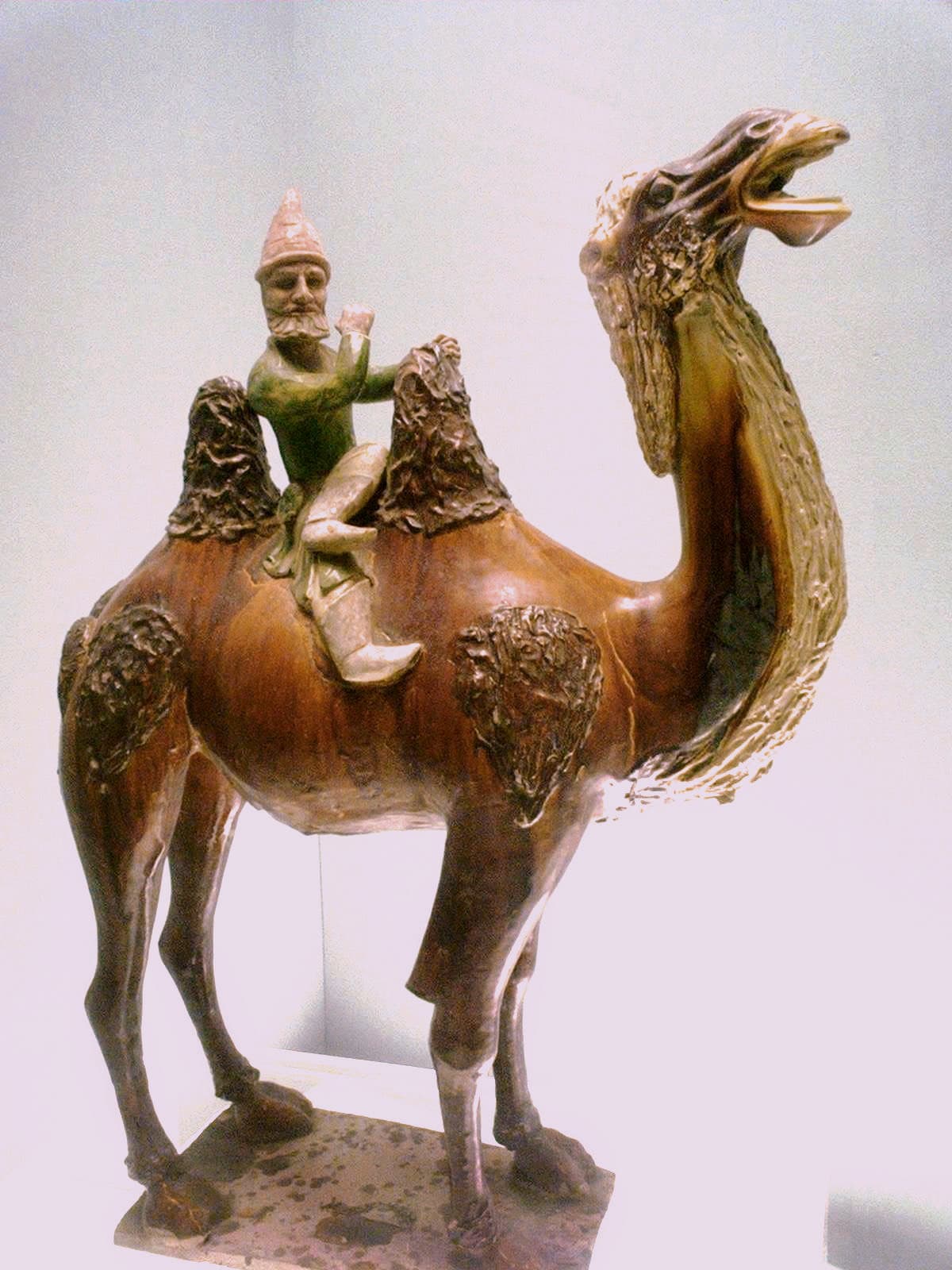 Glazed ceramic tomb figure of a bearded merchant riding a two-humped Bactrian camel